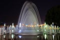 Picturesque, beautiful fountain against the background of the night sky in city. Evening view of Dnepropetrovsk, Ukraine, Dnipro