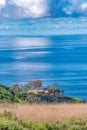 Picturesque blue sea and sky with sun behind clouds at Laguna Beach California Royalty Free Stock Photo