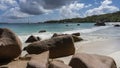 Picturesque boulders lie on the beach at the water\'s edge