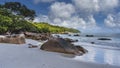 Picturesque boulders are scattered on a tropical beach. Royalty Free Stock Photo