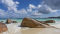 Picturesque boulders on a tropical beach are washed by waves. Royalty Free Stock Photo