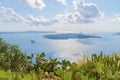 Picturesque cactuses and romantic panoramic view from a height on caldera,rocks and vulcan in Fira town at Santorini island.