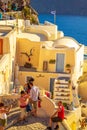 Picturesque carved houses on narrow alley in Oia Santorini