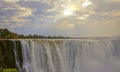 Picturesque celestial landscape with the rays of the morning sun over Victoria Falls Royalty Free Stock Photo