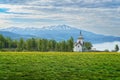 Picturesque church surrounded by lush green grass and trees in the Hardanger Fjord, Norway Royalty Free Stock Photo