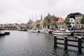 Picturesque cityscape with beautiful traditional houses and vessels in canal of Haarlem