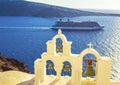 Church bells and cruise ship passing Oia town Santorini Greece