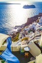 Carved houses terrace and cruise ship passing Oia Santorini Greece