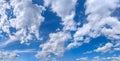 Picturesque cloud formations flow downwind across the blue sky. Diagonal, dynamic movement across the sky. Beautiful exploding Royalty Free Stock Photo
