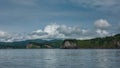 The picturesque coast of Kamchatka. Sheer cliffs and green hills against an azure sky Royalty Free Stock Photo