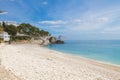 The picturesque coast of Mediterranean sea: white pebble beach and azure blue sky.