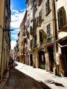 Picturesque cobblestone street adorned with quaint buildings in Toulon, France