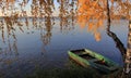 Picturesque colorful autumn landscape with a boat on the lake.