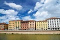 Picturesque colorful historic buildings along Arno river in Pisa, Italy