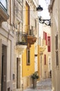 Picturesque and colorful Mediterranean pedestrian street with stone houses and balconies, in Rabat, Malta Royalty Free Stock Photo