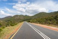 Picturesque countryside road with green mountains on the background Royalty Free Stock Photo