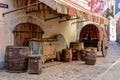 Picturesque decoration with middle-age wagon, wooden barrels and heavy chest near medieval
