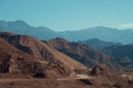 Picturesque desert mountain landscape featuring a meandering road winding through its terrain