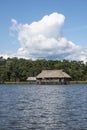 Picturesque and exotic lagoon with clean water El Milagro, loggon milagros with wooden house and thatched roof stilt houses Amazon Royalty Free Stock Photo