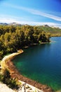 picturesque and exotic landscapes of lake and mountains with blue sky and yellow flowers in spring, san martin de los andes Royalty Free Stock Photo