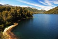 picturesque and exotic landscapes of lake and mountains with blue sky and yellow flowers in spring, san martin de los andes Royalty Free Stock Photo