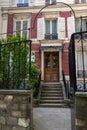 Picturesque facade of traditional European building with red brick wall and white shutters of windows. Entryway to house. Royalty Free Stock Photo