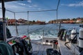 A picturesque fishing village on the Swedish West coast seen from the deck of a dive boat. Traditional red sea huts and