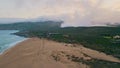 Picturesque fog beach seascape with coast washed by foamy blue ocean waves surfs Royalty Free Stock Photo