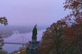 Picturesque foggy landscape of morning Kyiv in the Saint Volodymyr Hill. View of Saint Volodymyr monument and Dnipro River. Royalty Free Stock Photo