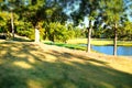 Picturesque golf course with a group of golfers playing their game in a lush green landscape Royalty Free Stock Photo