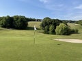 Picturesque golf hole with a pond and bunker Royalty Free Stock Photo