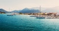 Picturesque Greece landscape with yacht during sunset. Wonderful colorful seascape. Sailing ship yachts with white sails at opened