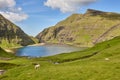 Picturesque green landscape with lambs in Faroe islands. Saksun