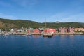 a harbor with boats, mountains, and a large ship in the water, Melbu, Norway