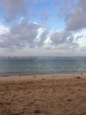 Picturesque horizon where a sandy beach lies on a cloudy afternoon