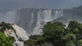 Picturesque Iguazu Falls. A stream of bubbling water falls from a cliff