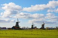 The picturesque landscape with aerial mill on the channel in Zaanse Schans, Holland on a background cloudy sky Royalty Free Stock Photo