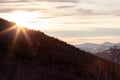 Picturesque landscape in the Altai mountains with snow-capped peaks under a blue sky with clouds and shining sun in a winter sunse Royalty Free Stock Photo