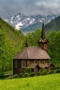 Picturesque landscape with church and high gables, meadow and green trees. Wooden church, Tatranska Javorina, High Tatra Mountains Royalty Free Stock Photo