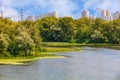 The picturesque landscape of the DniprÃÂ¾ Bay, a fisherman on a boat catches fish near the shore. The skyscrapers of the city`s