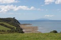 Picturesque landscape with green grass, rocky coastlines and an island on background, Shakespear Regional Park, New Zealand