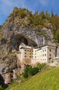 Picturesque landscape of medieval castle on cave. Famous Predjama castle Slovene. Predjamski grad