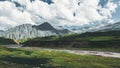 Picturesque landscape pastures for sheep near the mountain river in the Elbrus region in summer. Jyli Suu, North Caucasus, Russia Royalty Free Stock Photo