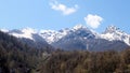 picturesque landscape of snow-capped mountains with white clouds on a blue sky on a sunny day at Krasnaya Polyana in Royalty Free Stock Photo