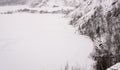 A picturesque landscape of a snow-covered quarry with skiers. Winter landscape Royalty Free Stock Photo