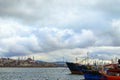 Picturesque landscape view of harbor with moored fishing boats and ships in Istanbul. Cityscape in the background Royalty Free Stock Photo