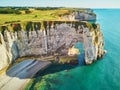 Picturesque landscape of white chalk cliffs and natural arches of Etretat, France