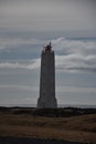 Picturesque Malarrif lighthouse stands on the beach, overlooking the vast expanse of the ocean