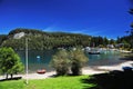 picturesque manzano bay, with luxurious hotels and apartments with docks and boats on lake nahuel huapi and mountains with blue sk