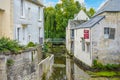 Picturesque medieval buildings along the Aure river in the Normandy town of Bayeux France near the old mill